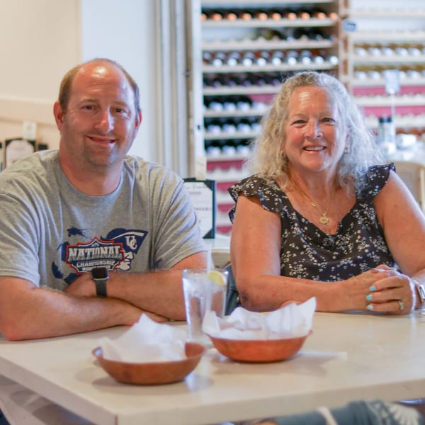 A smiling man and woman seated at a table in Scarpino's Classic Italian restaurant.