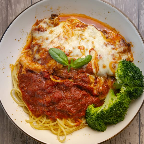Scarpino's baked spaghetti with melted cheese, marinara sauce, fresh basil, and broccoli florets.